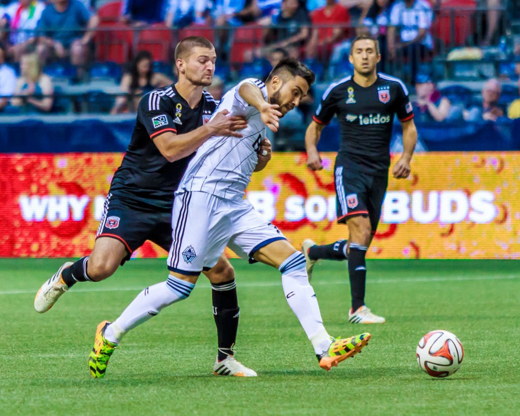 Pedro Morales fights off Perry Kitchen of DC United at BC Place. Photo courtesy of Christopher Vose of The Vancouver Herald.