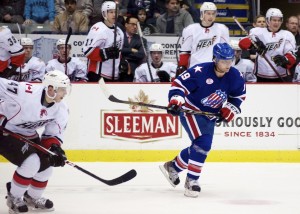 Sven Bärtschi of the Abbotsford Heat and Cody Hodgson of the Rochester Americans follow the puck up ice during a 5-2 Rochester win on January 3, 2013. Photo by Jason Kurylo for Pucked in the Head.