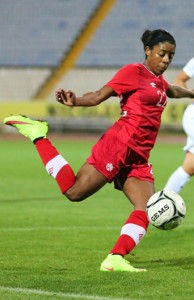 Team Canada midfielder Ashley Lawrence lays her right foot into the ball during an international friendly against England. Photo courtesy of Soccer Canada.