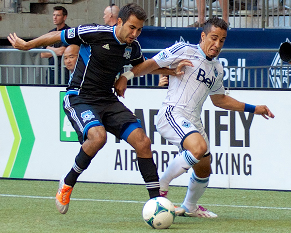 Camilo da Silva Sanvezzo battles defender Steven Baiteshour during a 2-0 Whitecaps FC victory at BC Place. Photo by Jason Kurylo for Pucked in the Head.