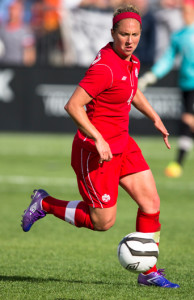 Team Canada defender Carmelina Moscato looks to clear a ball during an international friendly against the USA. Photo courtesy of Soccer Canada.