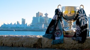 The Cascadia Cup wears Whitecaps FC, Southsiders and Rain City Brigade scarves (and a Curva Collective shirt for good measure) as it looks over Vancouver, its home for the 2014 MLS season, from a piece of prime Stanley Park Seawall real estate. Photo by Jason Kurylo for Pucked in the Head.