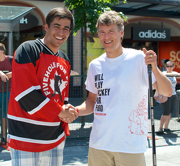 Five Hole for Food founder and CEO Richard Loat (left) and Vancouver mayor Gregor Robertson do the traditional après-game handshake. Photo by Jason Kurylo for Pucked in the Head.