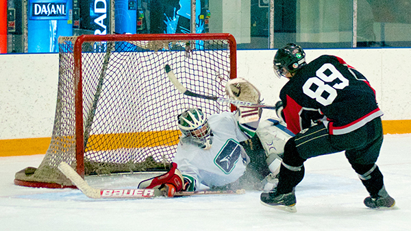 The CBC's Grant Lawrence makes a diving save with his mask during Duffers League action in North Vancouver. (The puck is actually visible under his neck protector if you look for it.) Photo by Jason Kurylo for Pucked in the Head.