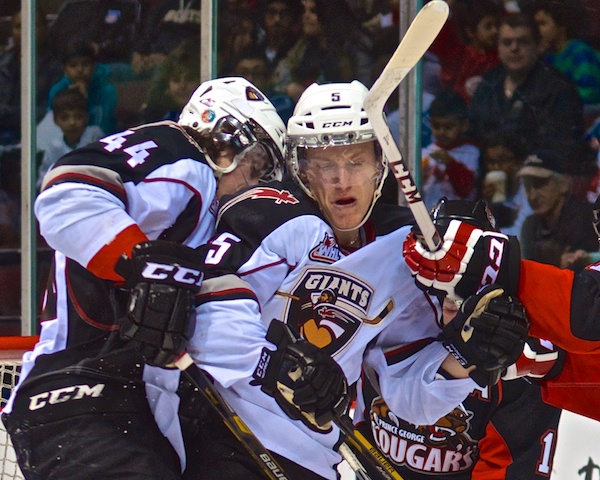 "Excuse me, pardon me, excuse me..." Mason Geertsen and Tyler Morrison get tangled up in Jared Rathjen's crease during WHL play. Photo by Jason Kurylo for Pucked in the Head.