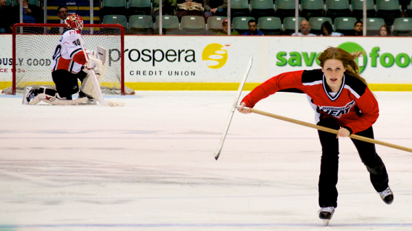 Abbotsford Heat ice crew member Kirsten picks up speed as Danny Taylor strikes his trademark pose during a TV timeout at the AESC. Photo by Jason Kurylo for Pucked in the Head.