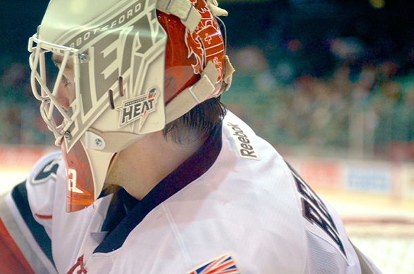 Abbotsford Heat goaltender Reto Berra looks at his options as he plays the puck during AHL action. Photo by Jason Kurylo for Pucked in the Head.