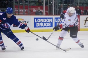 Rochester Americans forward Cody Hodsgon gets his stick in the way of a TJ Brodie shot during the a 5-2 win over the Abbotsford Heat. Photo by Jason Kurylo for Pucked in the Head.