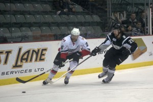 Tyler Ruegsegger of the Abbotsford Heat steps around San Antonio Rampage defenseman Colby Robak in AHL action on December 5 2012. Photo by Jason Kurylo for Pucked in the Head.