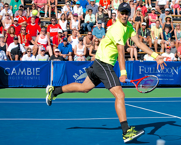 Vasek Pospisil stretches for a dramatic backhand volley during the third set of the Vancouver Open men's singles final. Photo by Jason Kurylo for Pucked in the Head.