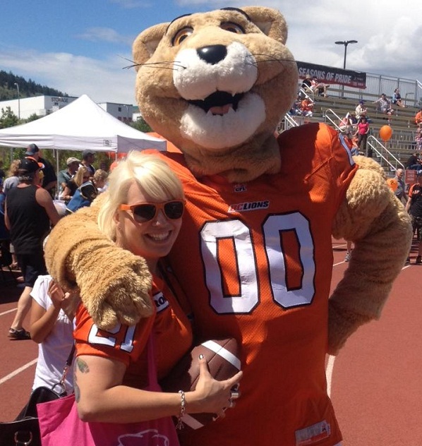 Sam Anderson (@SamelaAnderson on the mighty Twitter) cavorts with Leo the Lion at the 2013 BC Lions Fan Fest in Kamloops. Photo courtesy of Sam's Facebook page.