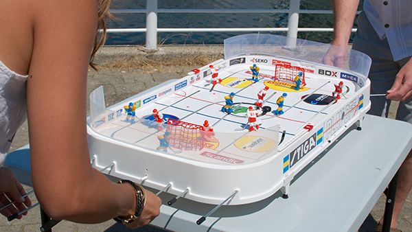 Marie Hui gets her first taste of table hockey action at False Creek in July 2013. She's hooked! Photo by Jason Kurylo for Pucked in the Head.