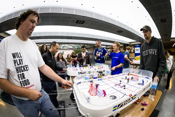 Chris Withers (left) sports a Five Hole for Food shirt during the Vancouver Table Hockey Extravaganza in Robson Square. Photo by Clint Trahan/ShutterDreams.