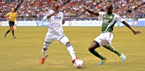 Darren Mattocks of Vancouver Whitecaps FC attempts to get round Portland Timbers defender Pa Modou Kah in MLS action. Photo by Jason Kurylo for Pucked in the Head.