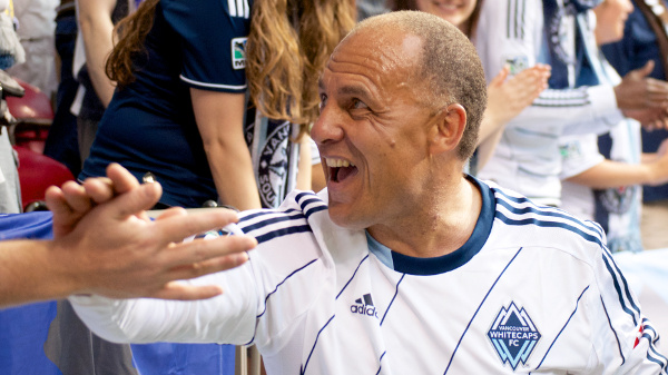 Whitecaps FC ambassador Carl Valentine walks the sidelines shaking hands of the Southsiders supporters group on 15 June 2013. Photo by Jason Kurylo for Pucked in the Head.