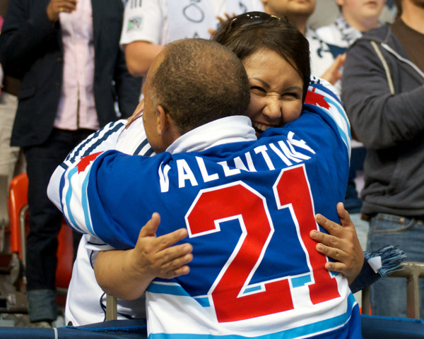 Whitecaps FC ambassador Carl Valentine hugs an appreciative member of the Curva Collective during MLS action on 15 June 2013. Photo by Jason Kurylo for Pucked in the Head.