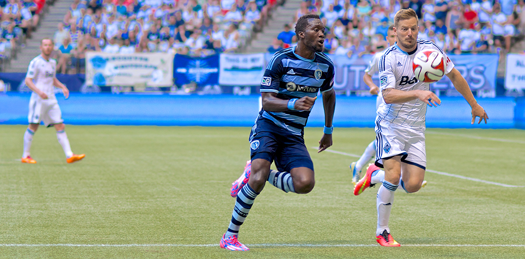 Jordan Harvey and C. J. Sapon race for the ball during a 2-0 Vancouver Whitecaps victory over Sporting KC, the top club in the MLS Eastern Conference. Photo by Jason Kurylo for Pucked in the Head.