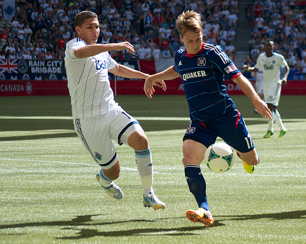 Johnny Leveron keeps a close eye on Chris Rolfe, who was unable to capitalize on an early handball missed by officials. Vancouver Whitecaps FC defeated Chicago Fire 3-1 on 14 July 2013 on the strength of two goals by Camilo de Sanvezzo. Photo by Jason Kurylo for Pucked in the Head.