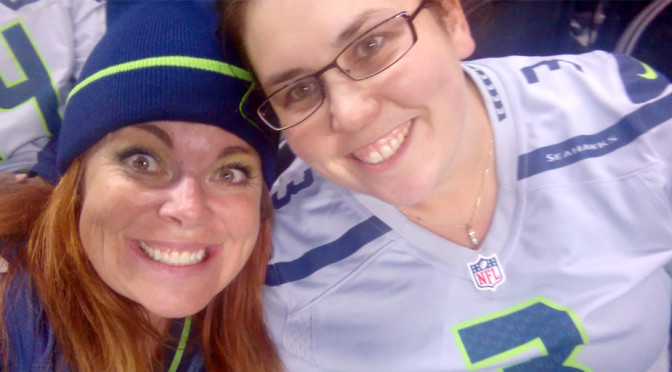 Erin Jeffery and friend at a Seattle Seahawks preseason game. Erin is not wearing a toque. Selfie by Erin Jeffery.